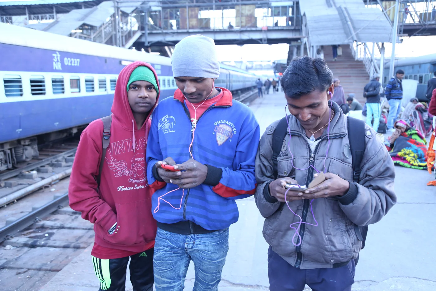 Young travellers at the platform installation on launch day, phones out to receive their playlists.