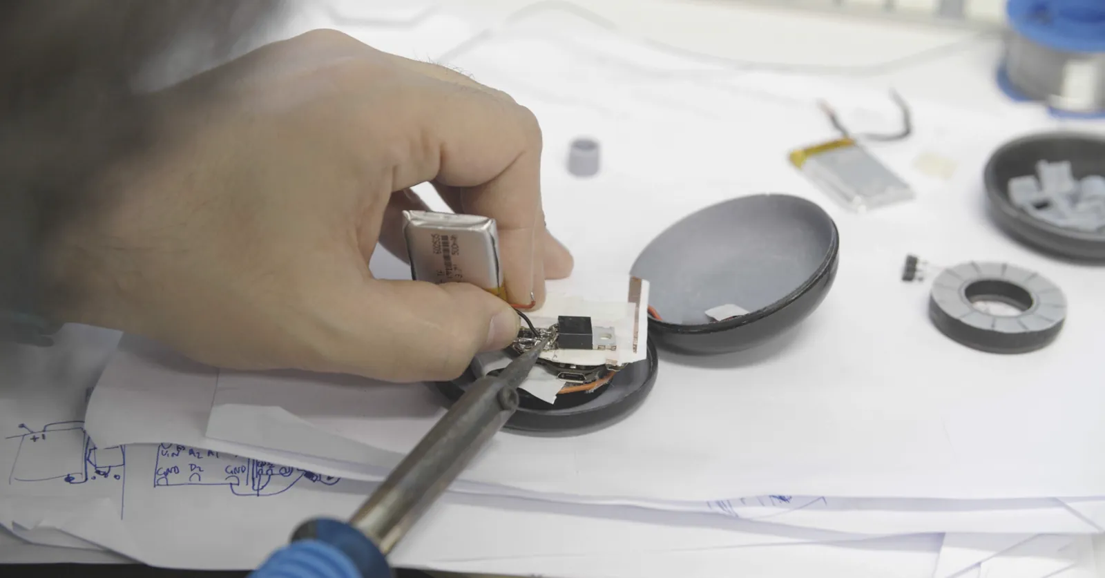 Soldering the custom electronics and battery into the device shell.