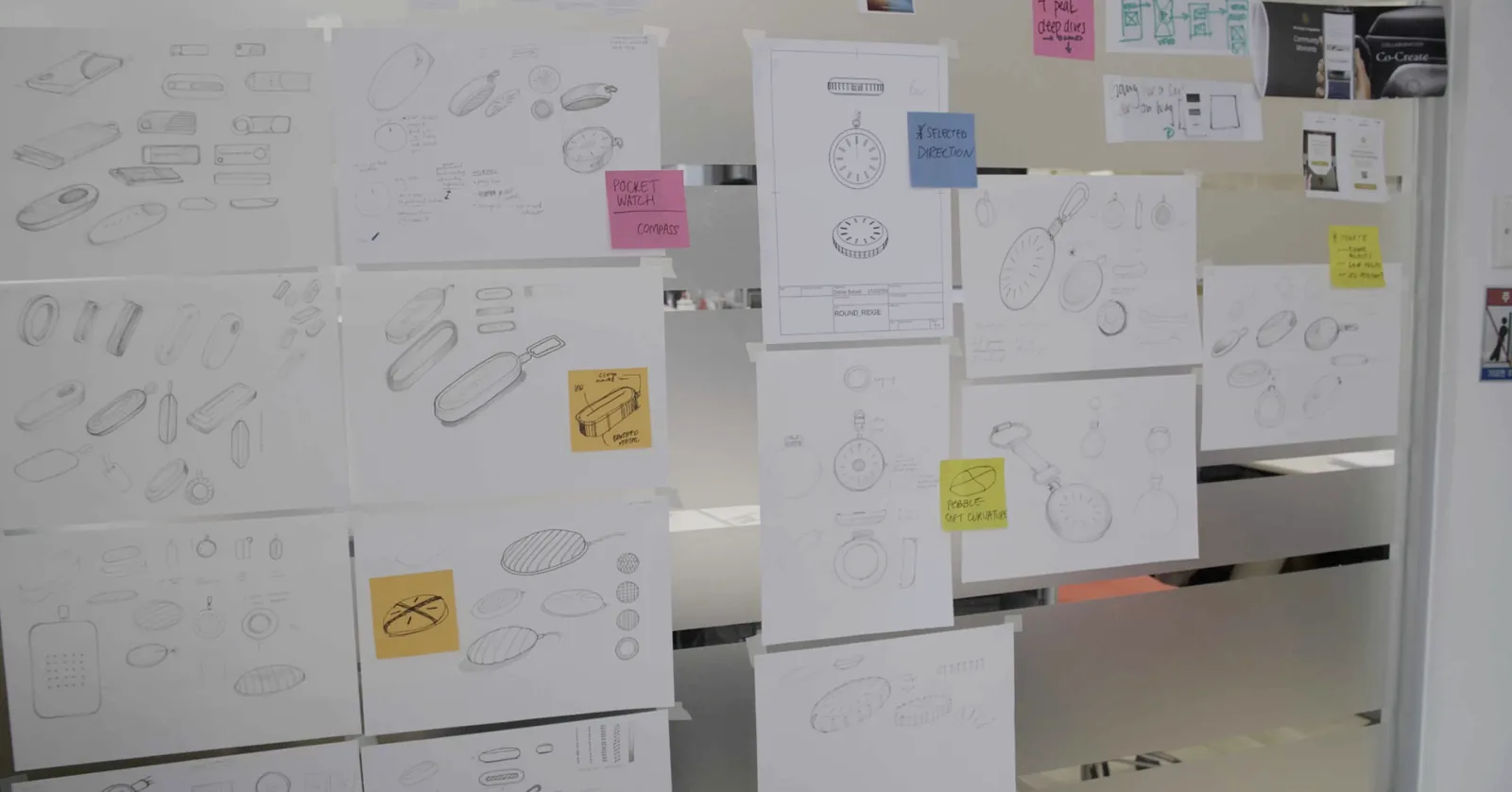 Industrial-design sketch wall exploring key-fob forms, with a selected pocket-watch / compass direction.